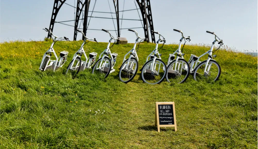 A row of walking bikes on the dyke at the IJzeren Kaap lookout